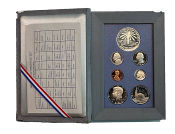 США годовой набор из 7 монет (1, 5, 10 (дайм), 25 (1/4 доллара, квотер) и 50 центов (1/2 доллара); 1 доллар) 1986 100 лет Статуе Свободы, в оригинальной коробке, с сертификатом KM 201b, A192, 195a, 164a, A202b, 212 и 214 PROOF 3-4-10-103